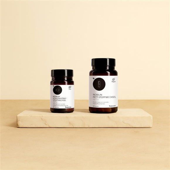 Das Figur-Set von Medicom mit der Dose von Nobilin Kohlenhydrat-Stoffwechsel Aktiv und Nobilin Fett-Stoffwechsel Aktiv